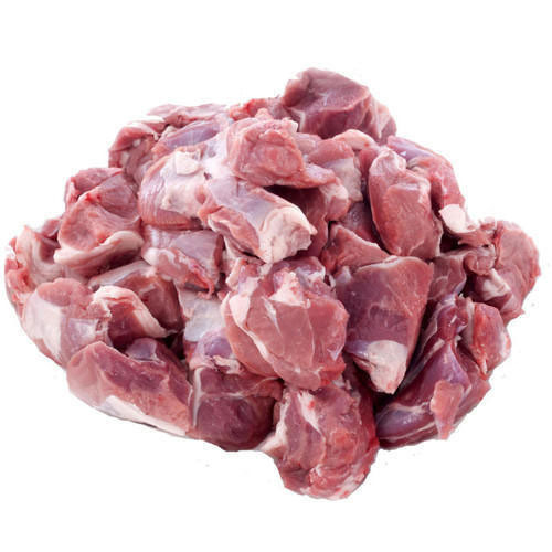 Meat delivery Dubai: Fresh, tender raw meat cuts on a wooden board, ready for cooking, with herbs and spices on the side."