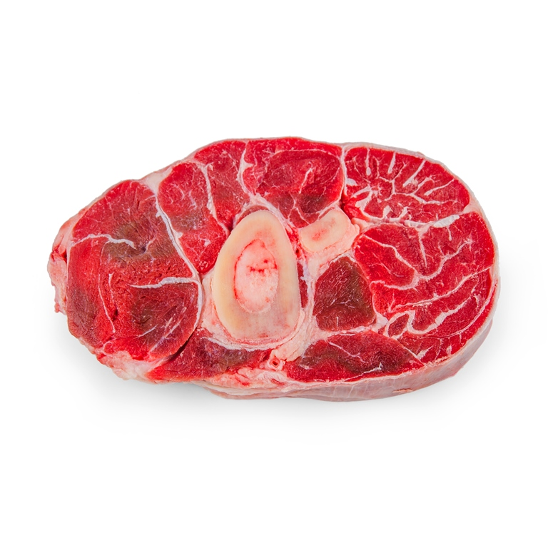 Meat delivery Dubai: Fresh, tender raw meat cuts on a wooden board, ready for cooking, with herbs and spices on the side.