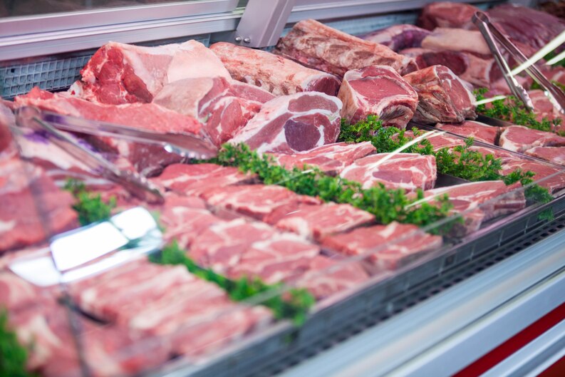 Freshly packed premium cuts ready for meat delivery Dubai, displayed in eco-friendly packaging on a wooden table.