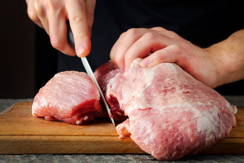Image showing fresh meat packages in a chilled delivery box labeled for pork delivery Dubai service.